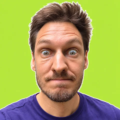 Thomas Kanze, wide-eyed, on a bright green background